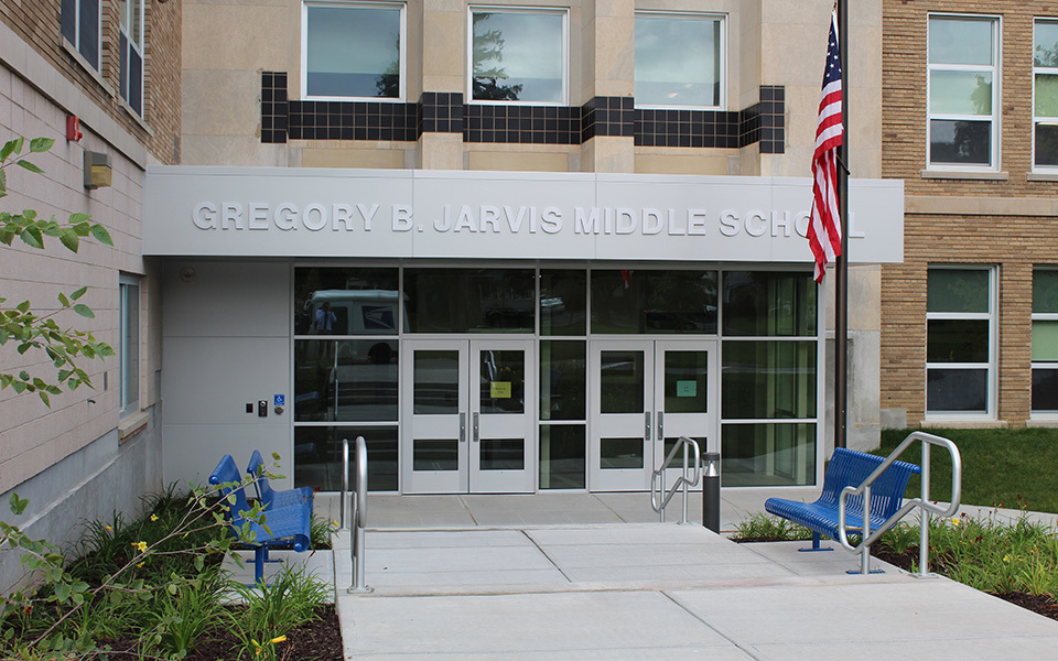 front of school building, doors, steps, flag