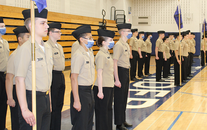 cadets in uniform standing at attention in gymnasium