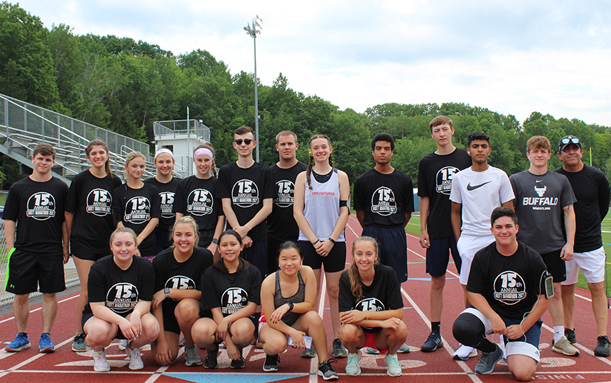 Group photo 22 runners outdoors on track, sky, trees