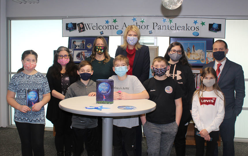 10 people standing, wearing masks, library