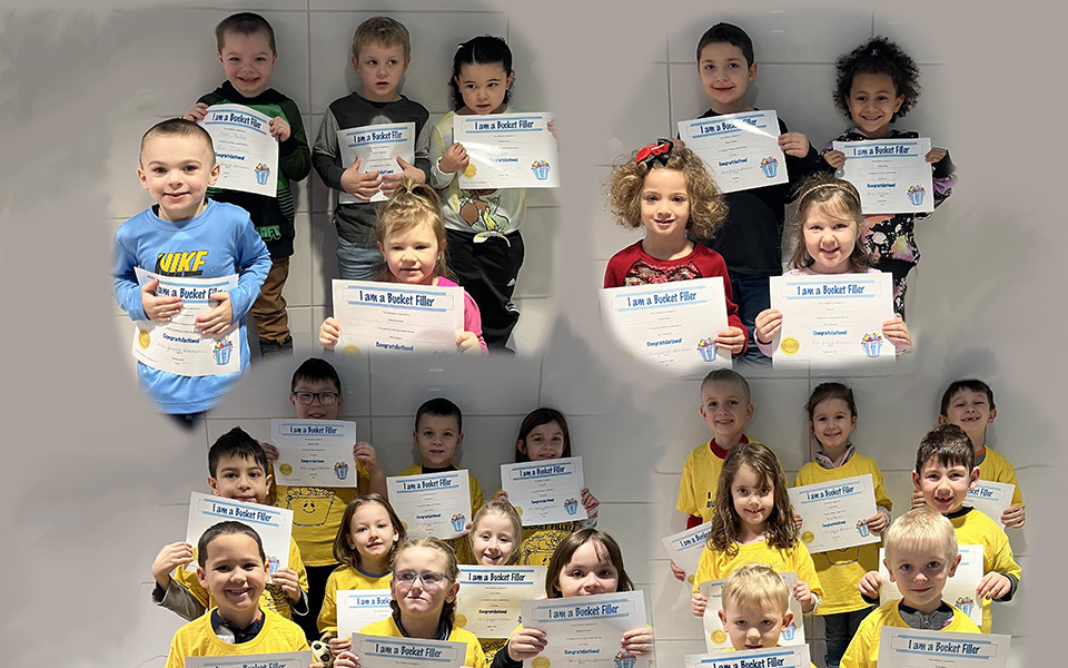 collage of small children holding their certificates
