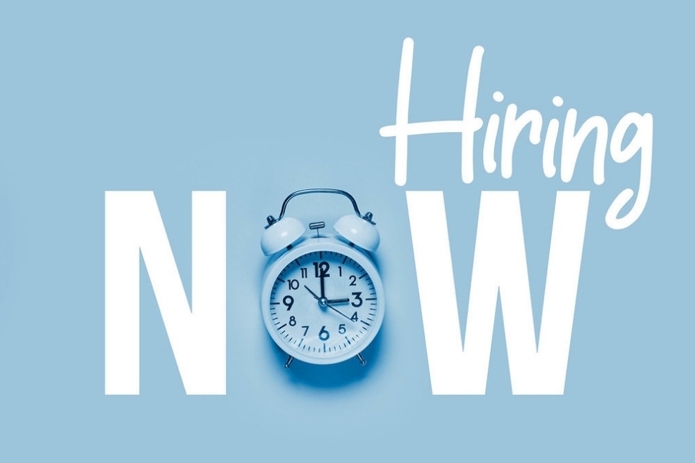 Hiring Now graphic with clock as the O in now. Blue background white lettering.