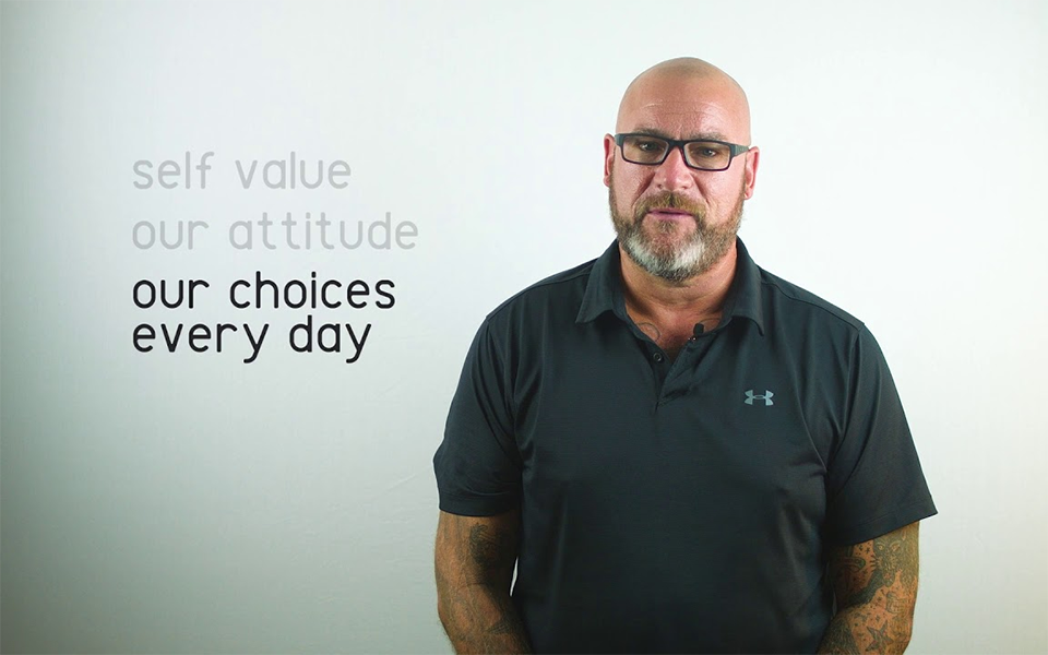 man, glasses text: self value our attitude our choices every day