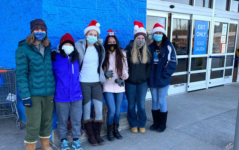 6 people outdoors, masked, winter clothes, Santa caps