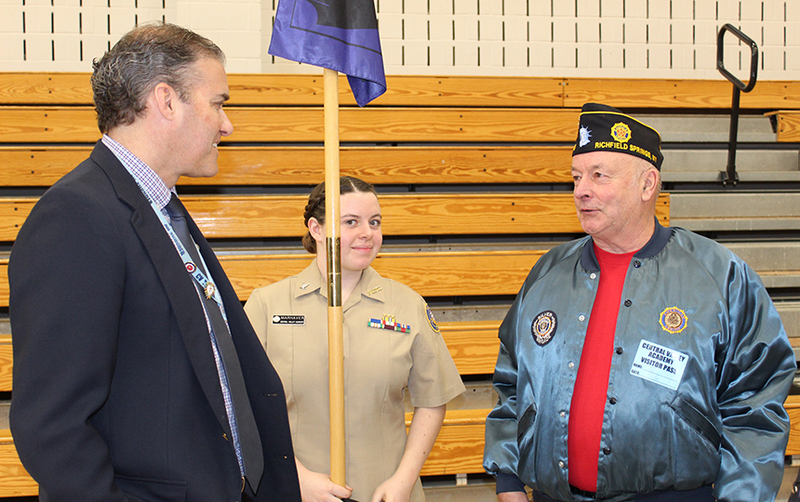 man in suit, cadet in uniform, man in tie with American Legion cap