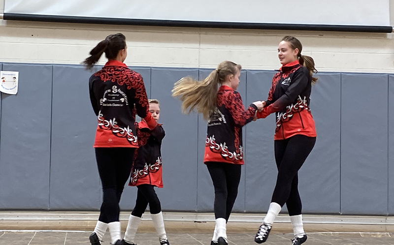 four girls dancing in gym