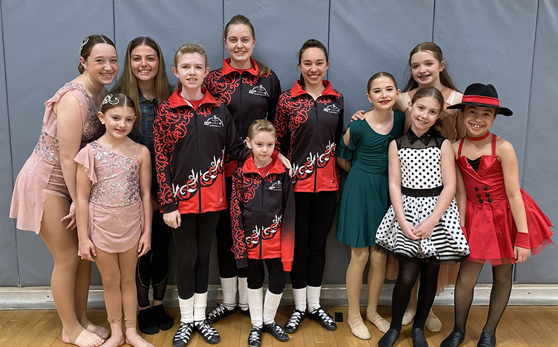 group photo of dancers in different costumes