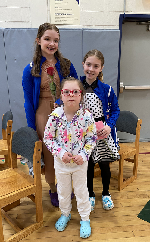 three young students, smiling, chairs, gymnasium