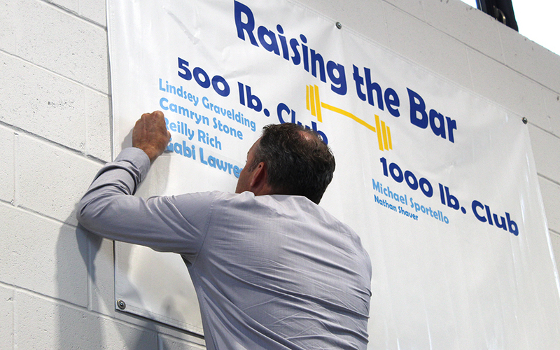 man adding name to banner