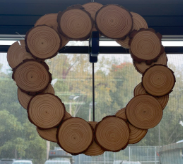 log wreath hanging in window