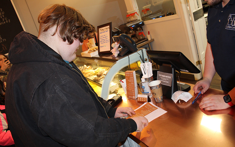 boy at counter looking at menu