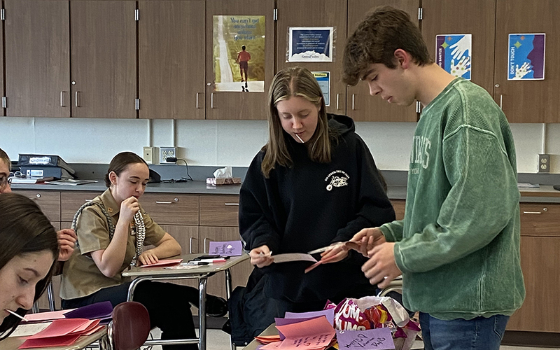 4 students, classroom, cupboards, desks, making cards