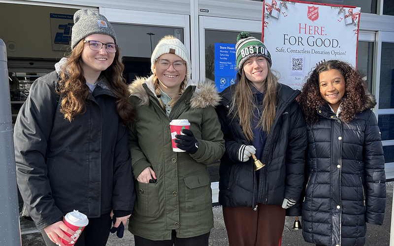 4 girls, outdoors, winter clothing, Salvation Army sign